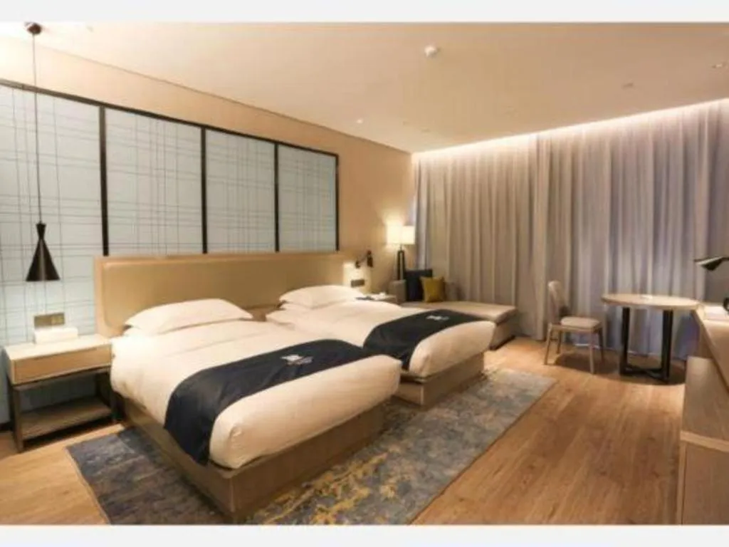Bed in Echarm Hotel Liuzhou Liunan Wanda Plaza