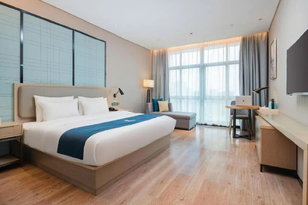 Bed in Echarm Hotel Liuzhou Liunan Wanda Plaza