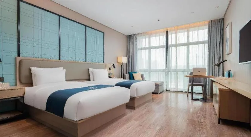 Bed in Echarm Hotel Liuzhou Liunan Wanda Plaza
