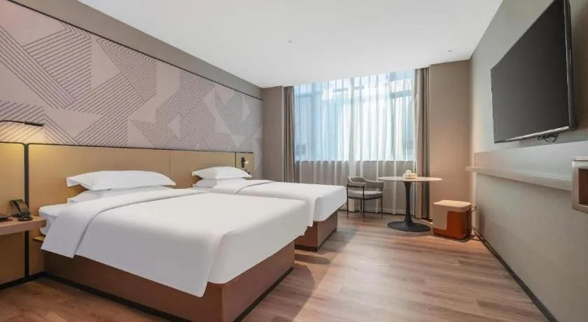 Bed in Borrman Hotel Qianjiang High-speed Railway Station Lobster City