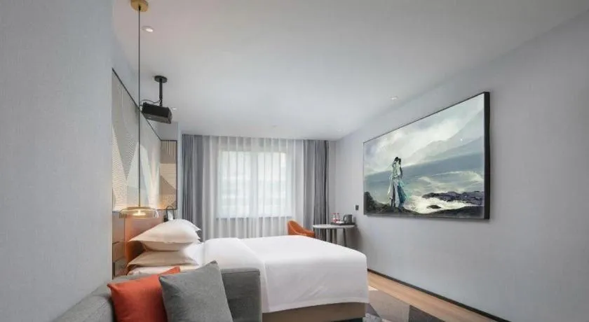 Bed in Borrman Hotel Qianjiang High-speed Railway Station Lobster City