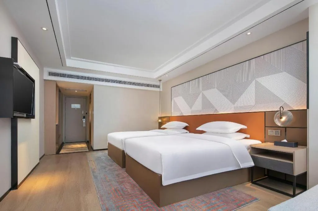 Bed in Borrman Hotel Qianjiang High-speed Railway Station Lobster City