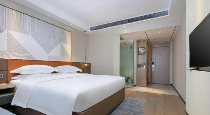 Bed in Borrman Hotel Qianjiang High-speed Railway Station Lobster City