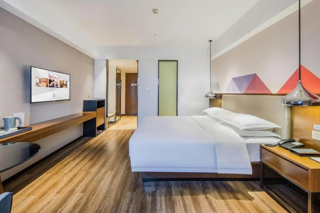 Bed in Borrman Hotel Qianjiang High-speed Railway Station Lobster City