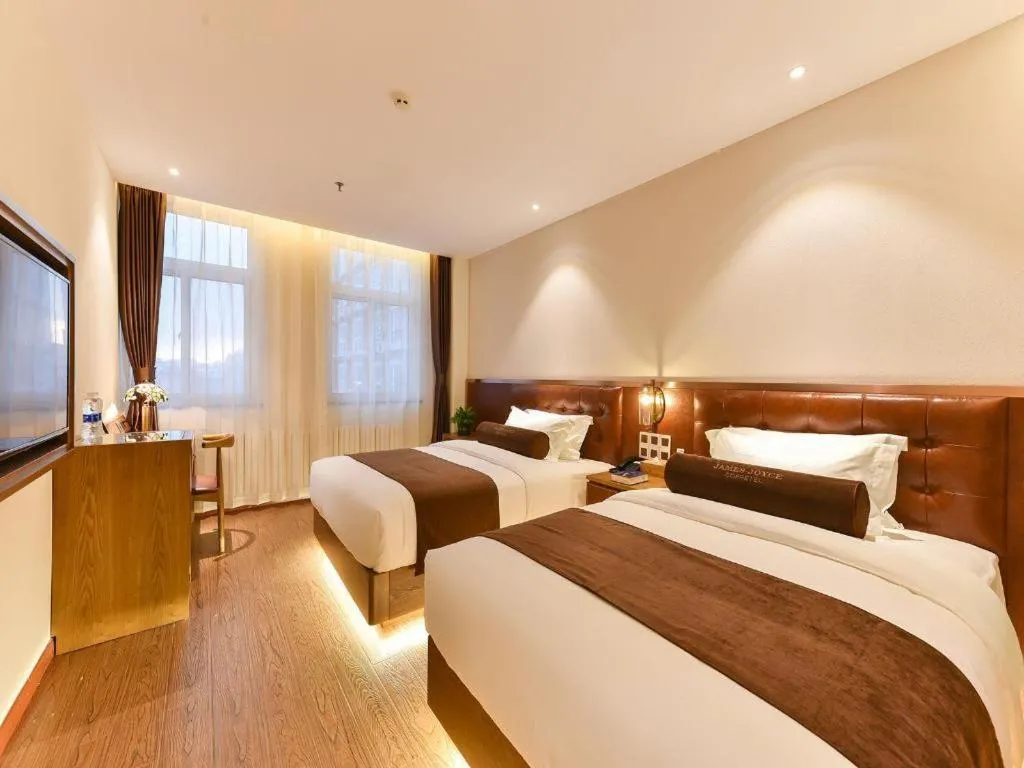 Bed in James Joyce Coffetel Shijiazhuang the Mixc Jinyuan Tower Airport Bus