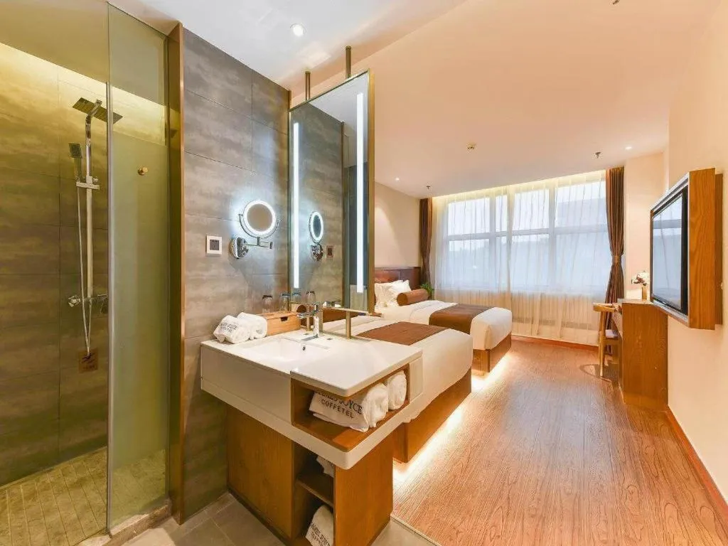 Bed in James Joyce Coffetel Shijiazhuang the Mixc Jinyuan Tower Airport Bus