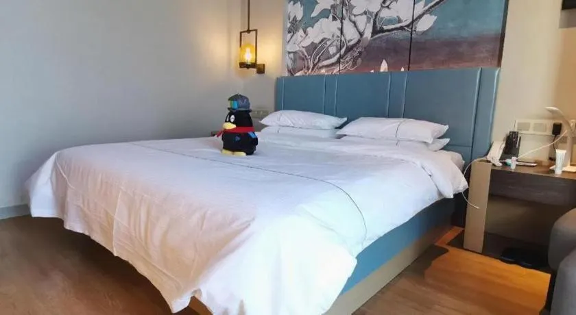 Bed in Magnotel Tongxiang Shimao Center