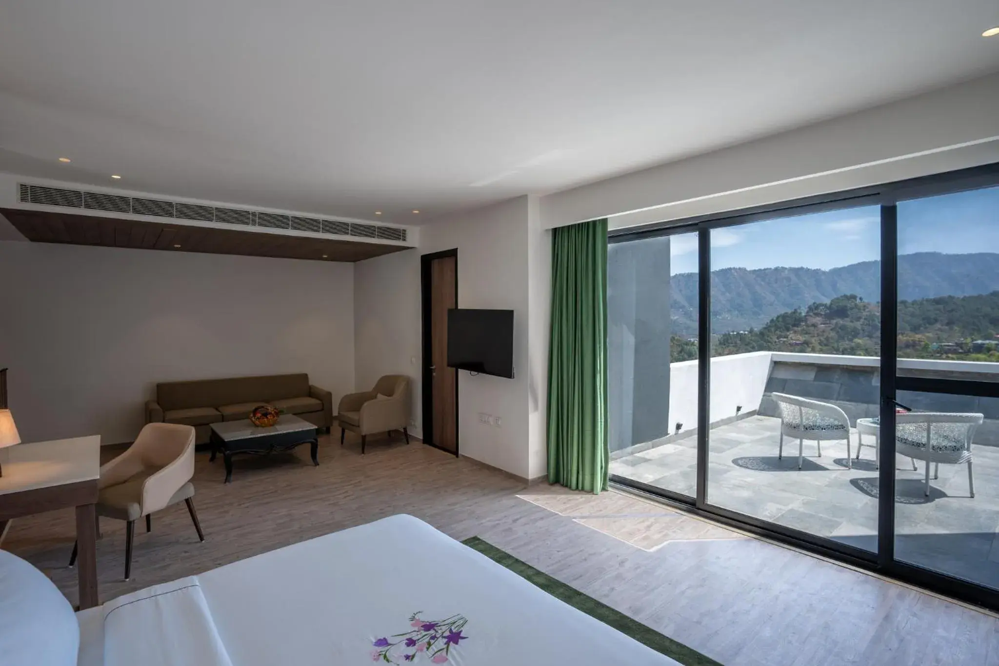 Seating area, Bed in Velmore Kasauli Operated by Royal Orchid Hotel Ltd. Seating area, Bed in Velmore Kasauli Operated by Royal Orchid Hotel Ltd.