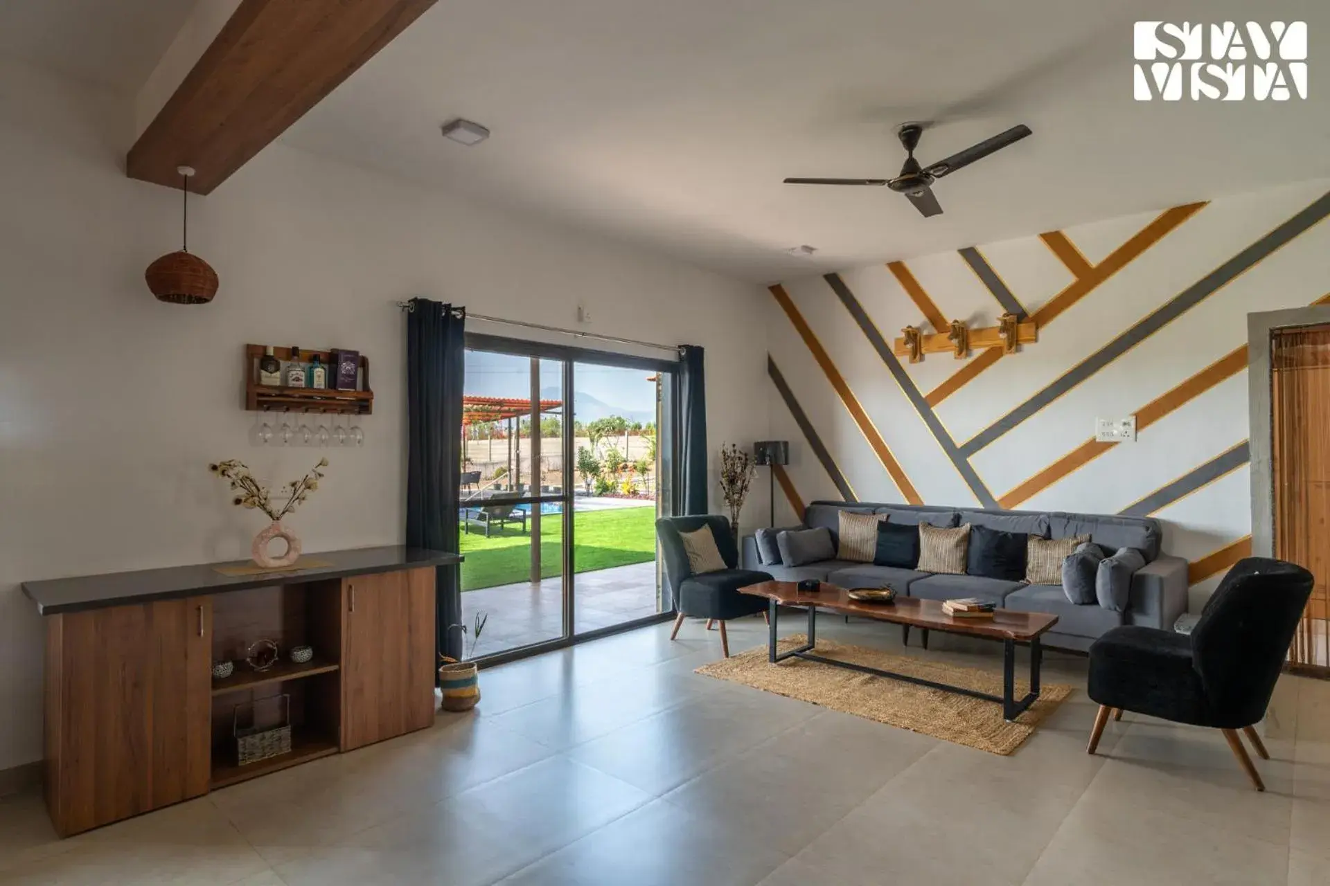 Living room in StayVista at Mangifera Agro Estate with Pool, Wi-Fi Living room in StayVista at Mangifera Agro Estate with Pool, Wi-Fi