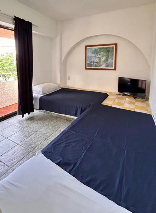 Bed in Íkaro Suites Cancún