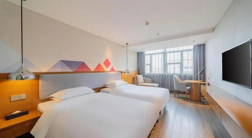 Bed in Borrman Hotel Zhanjiang Wuchuan Jinsha Plaza