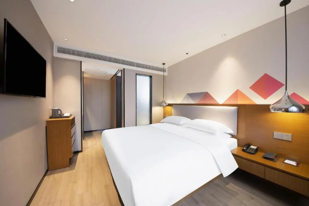 Bed in Borrman Hotel Zhanjiang Wuchuan Jinsha Plaza