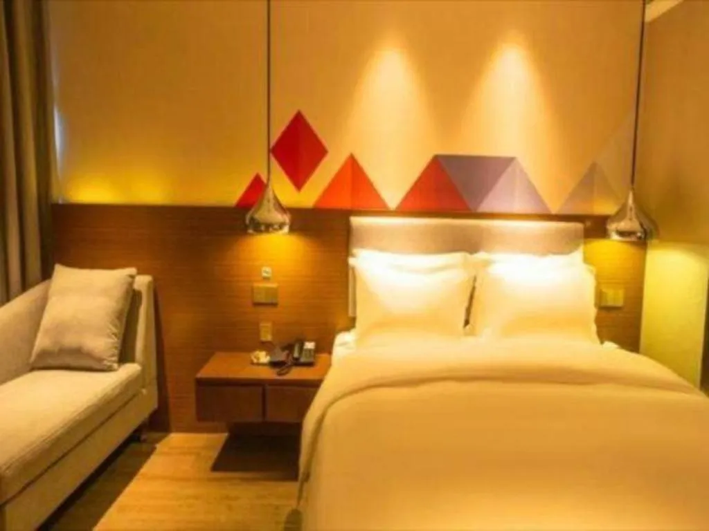 Bed in Borrman Hotel Zhanjiang Wuchuan Jinsha Plaza