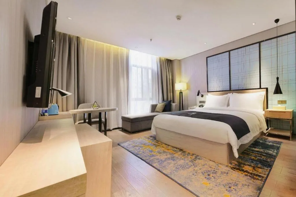 Bed in Echarm Hotel Kunming High-speed Railway South Station Chunrong Street Metro Station