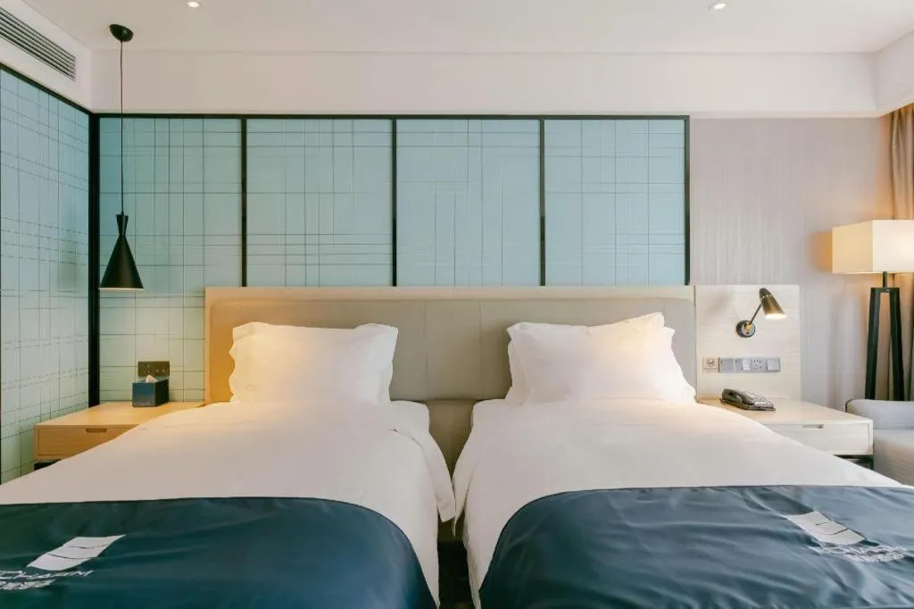 Bed in Echarm Hotel Kunming High-speed Railway South Station Chunrong Street Metro Station