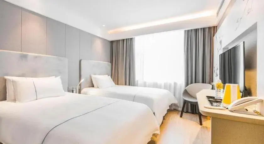 Bed in Magnotel Hotel Huangshan Scenic Area Transfer Center Bed in Magnotel Hotel Huangshan Scenic Area Transfer Center