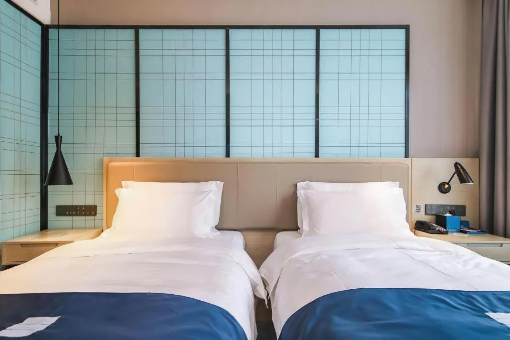 Bed in Echarm Hotel Changsha Wuyi Square Railway Metro Station