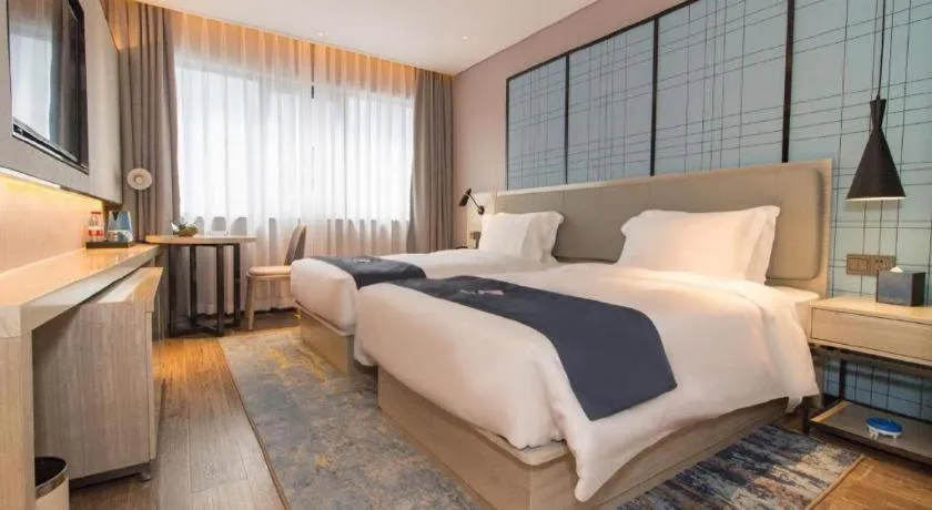 Bed in Echarm Hotel Changsha Wuyi Square Railway Metro Station