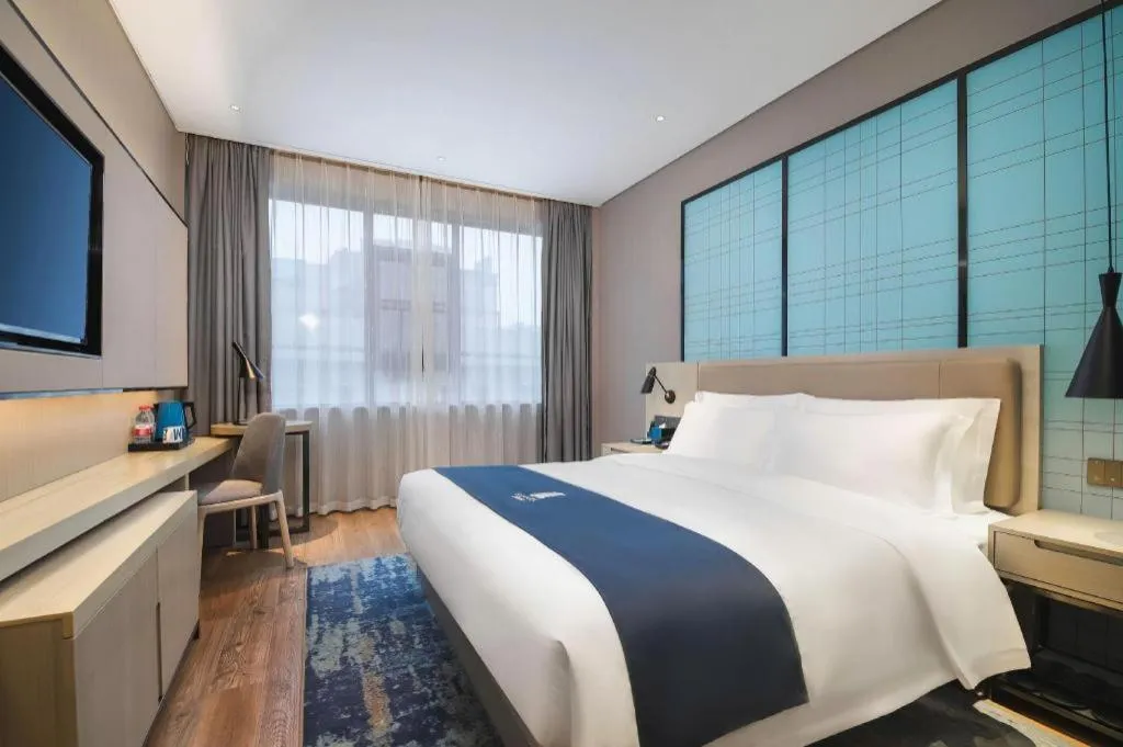Bed in Echarm Hotel Changsha Wuyi Square Railway Metro Station