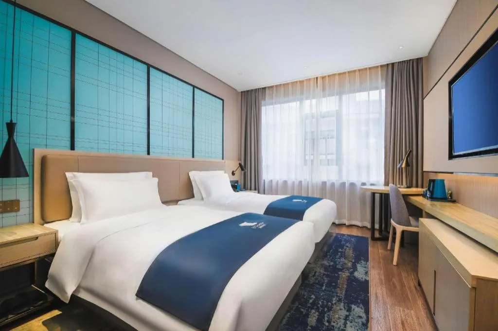 Bed in Echarm Hotel Changsha Wuyi Square Railway Metro Station