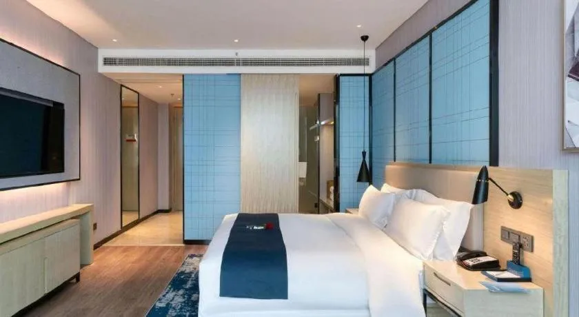 Bed in Echarm Hotel Nanjing Lishui High-speed Railway Station Wuzhou Commercial City
