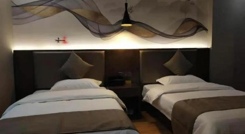 Bed in Shell Hotel Zhengzhou East High-Speed Railway Station Zhengdong Commerical Center