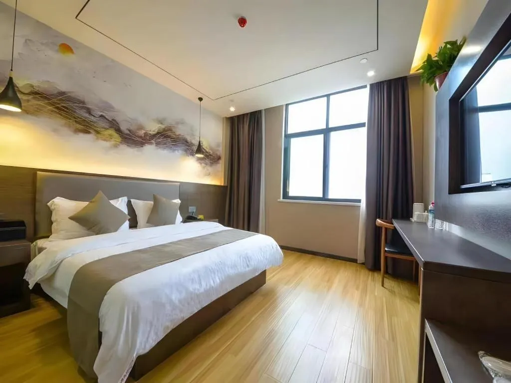 Bed in Shell Hotel Zhengzhou East High-Speed Railway Station Zhengdong Commerical Center