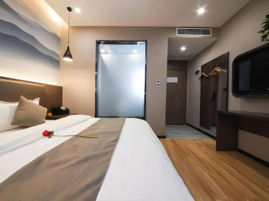 Bed in Shell Hotel Zhengzhou East High-Speed Railway Station Zhengdong Commerical Center