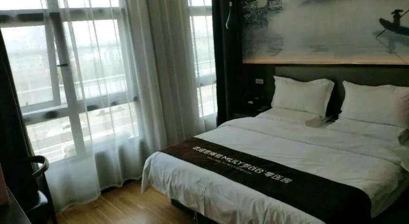 Bed in Shell Hotel Zhengzhou East High-Speed Railway Station Zhengdong Commerical Center