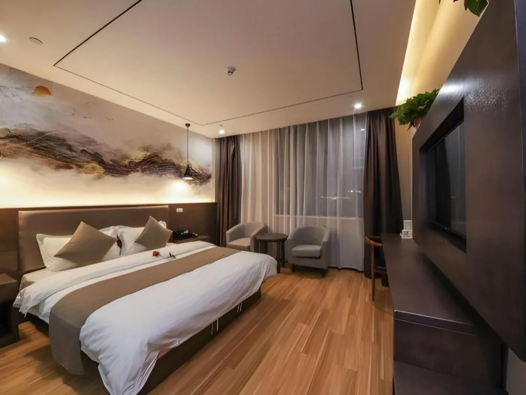 Bed in Shell Hotel Zhengzhou East High-Speed Railway Station Zhengdong Commerical Center