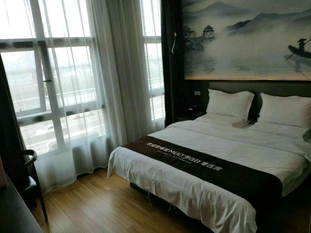 Bed in Shell Hotel Zhengzhou East High-Speed Railway Station Zhengdong Commerical Center
