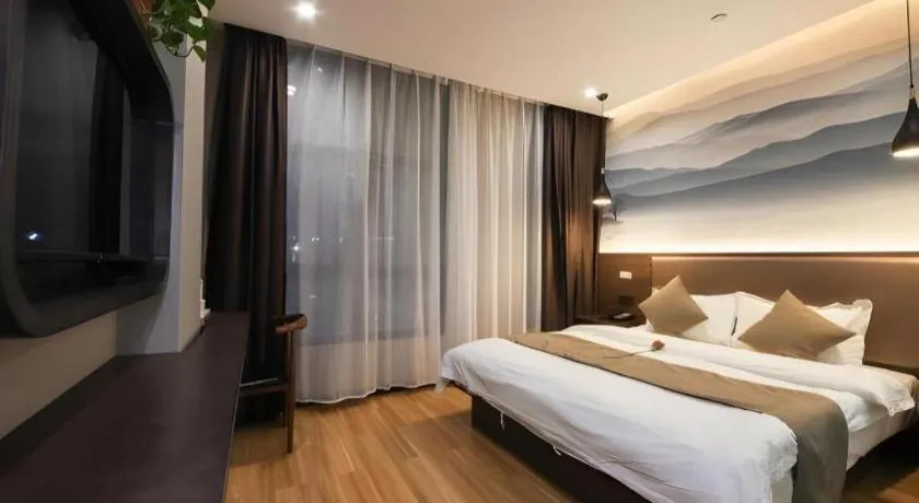 Bed in Shell Hotel Zhengzhou East High-Speed Railway Station Zhengdong Commerical Center
