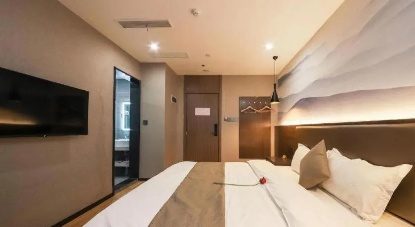 Bed in Shell Hotel Zhengzhou East High-Speed Railway Station Zhengdong Commerical Center