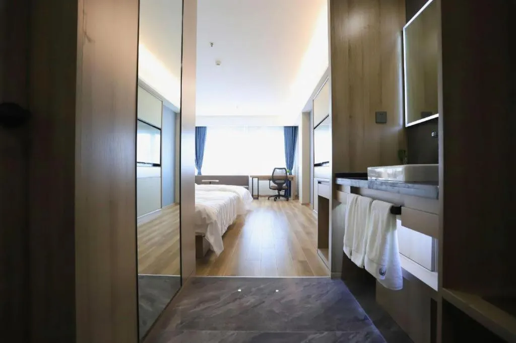 Bed in VX Hotel Jiangsu Taizhou Xinghua RT-Mart