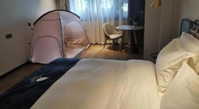 Bed in Echarm Hotel Liuzhou Yaobu Ancient Town