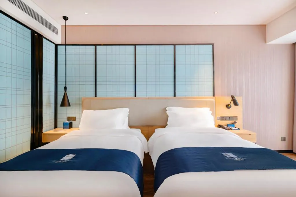 Bed in Echarm Hotel Suzhou Shengze Oriental Extile City