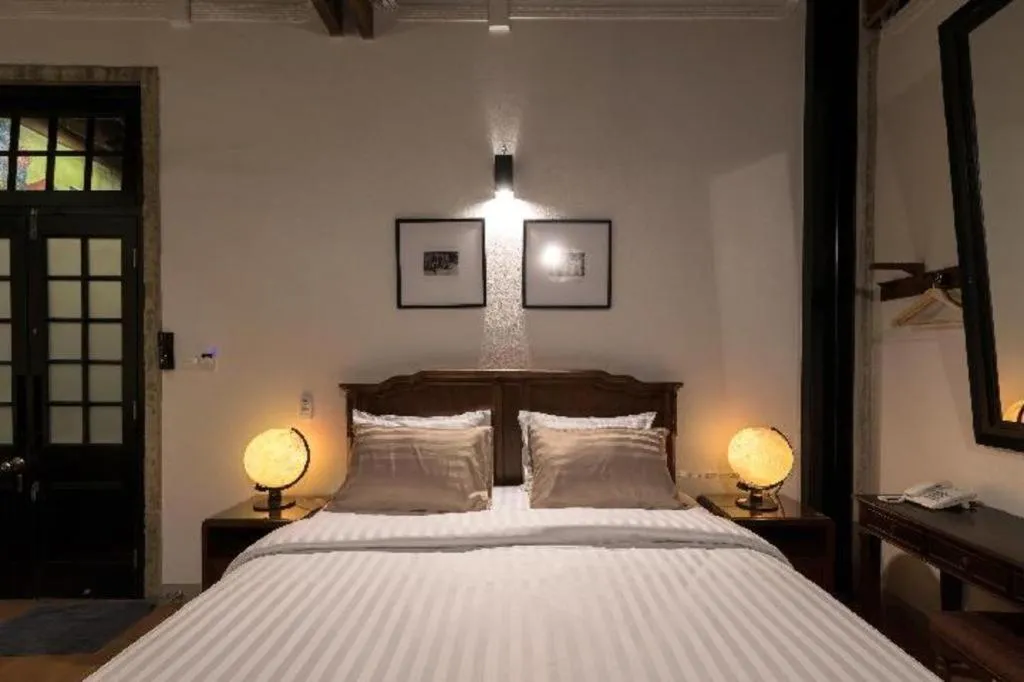 Bed in Uthai Heritage Hotel