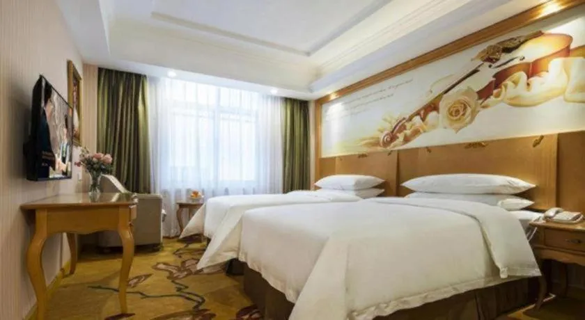 Bed in Vienna Hotel Guangdong Huidong Herung Pedestrian Street