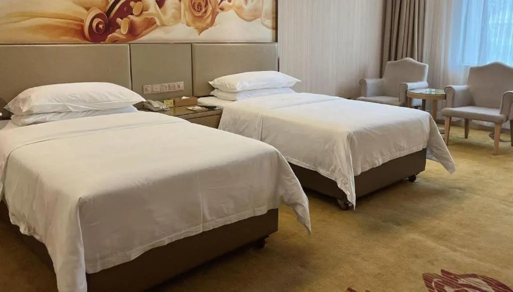 Bed in Vienna Hotel Guangdong Huidong Herung Pedestrian Street