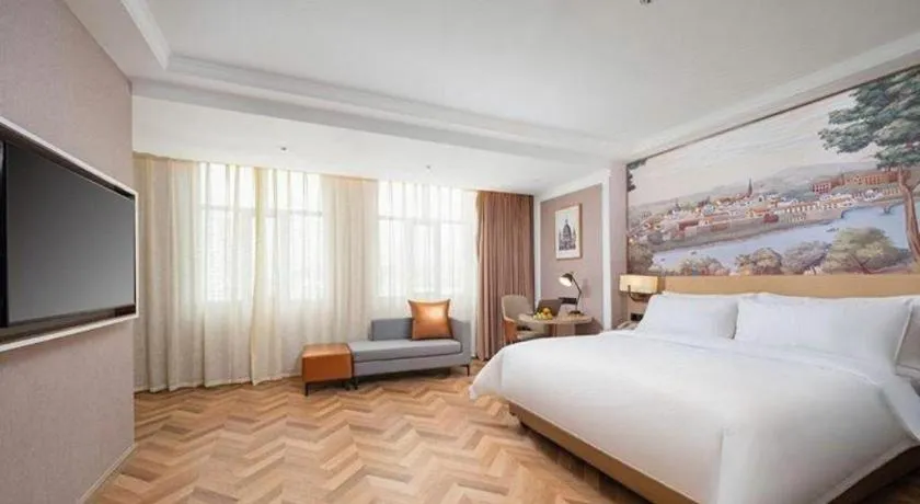 Bed in Vienna Hotel Lincang New Asia Pacific Times Square