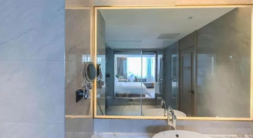 Bed in Vienna Hotel Lincang New Asia Pacific Times Square