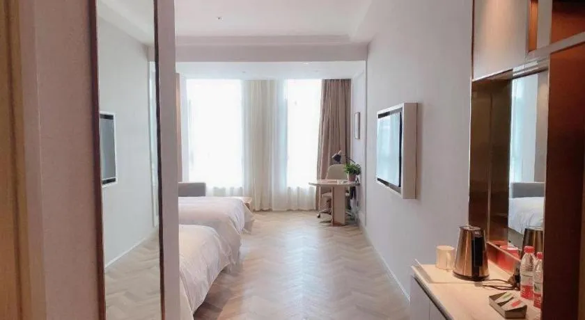 Bed in Vienna Hotel Lincang New Asia Pacific Times Square