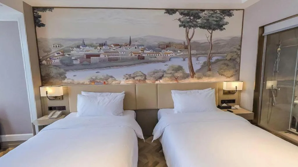 Bed in Vienna Hotel Lincang New Asia Pacific Times Square