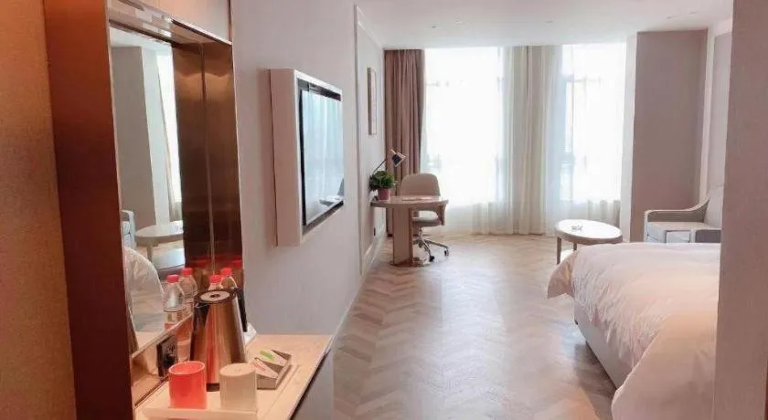 Bed in Vienna Hotel Lincang New Asia Pacific Times Square