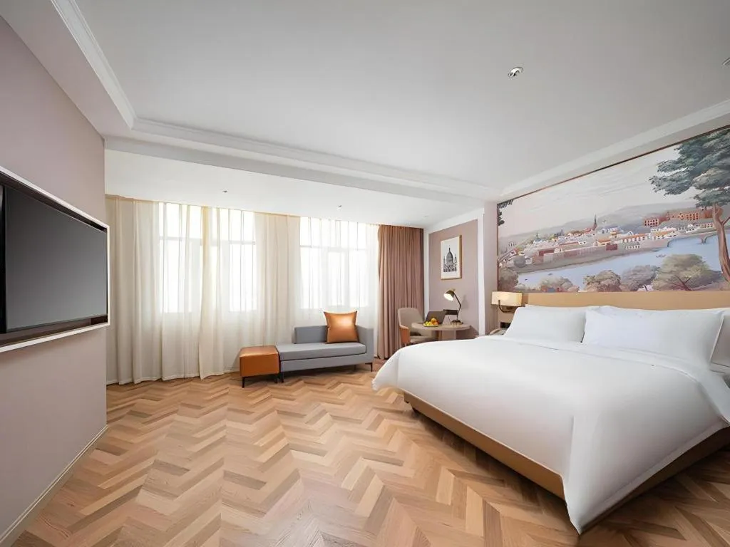 Bed in Vienna Hotel Lincang New Asia Pacific Times Square