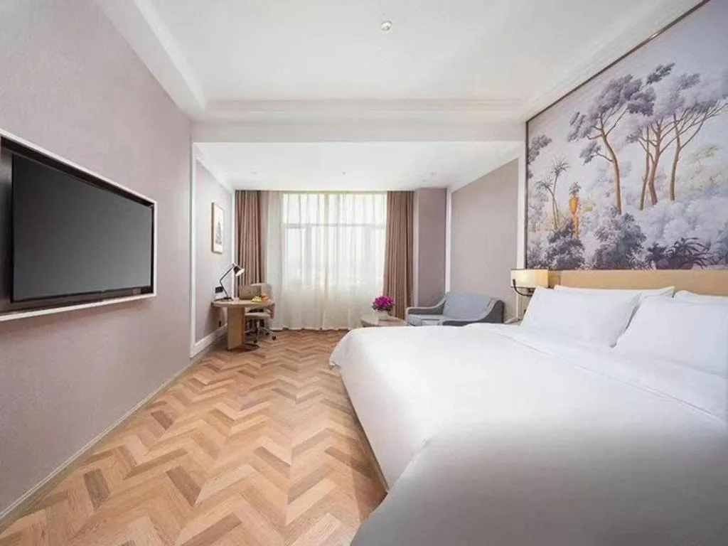 Bed in Vienna Hotel Lincang New Asia Pacific Times Square