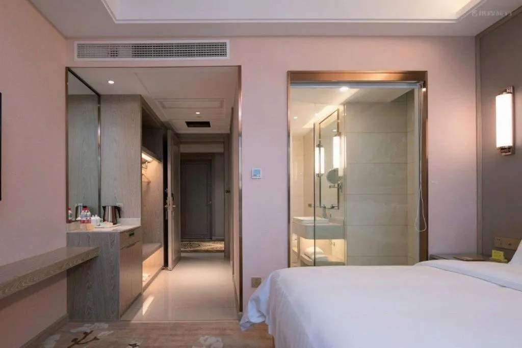 Bed in Vienna Hotel Lincang New Asia Pacific Times Square