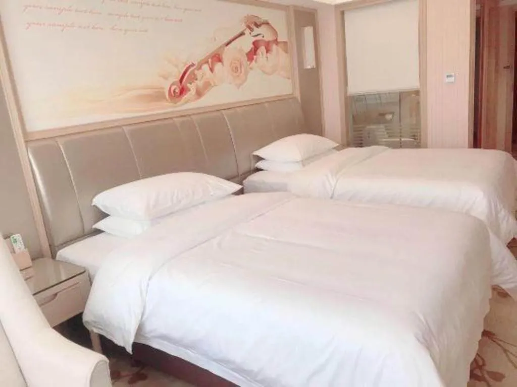 Bed in Vienna Hotel Guangxi Zhongshan Central Plaza West High-Speed Railway Station