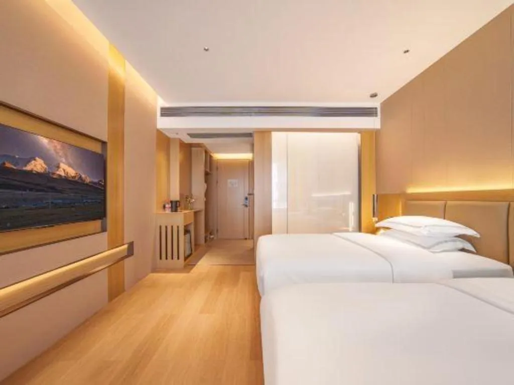 Bed in Vienna Hotel Yunnan Maitreya Huquan