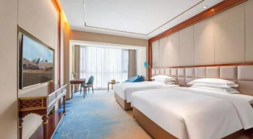 Bed in Vienna Hotel Yunnan Maitreya Huquan